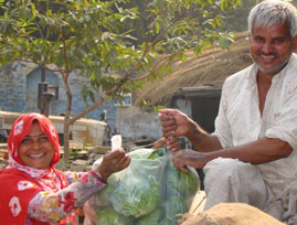 Indian man and women showing off crop